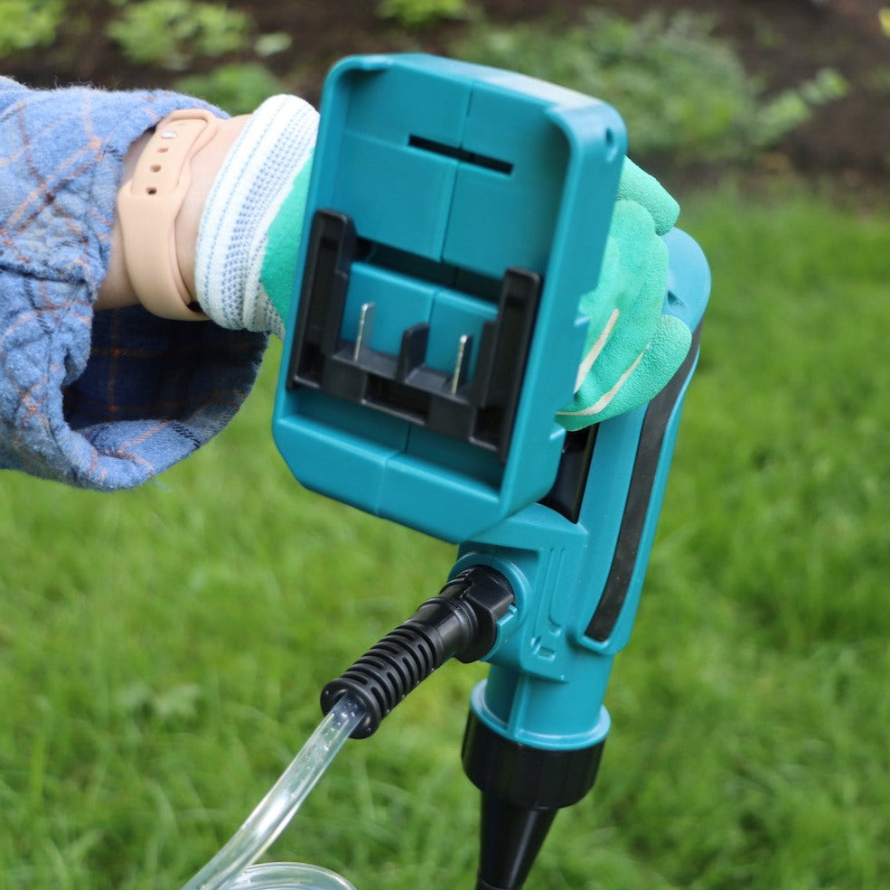 hand holding up spray gun showing the bottom battery holster