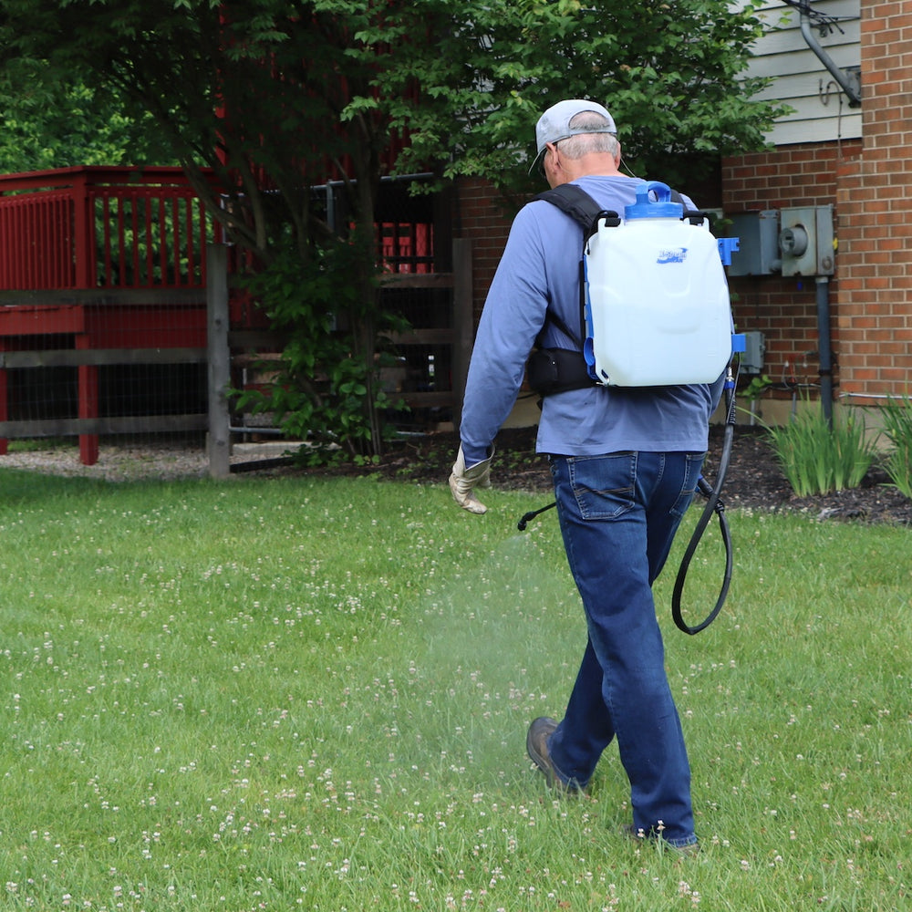 man spraying lawn with microburst 2.0